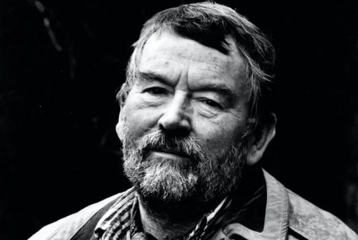 A black and white archival portrait of British author John Fowles looking thoughtful, dating from the mid-20th century.