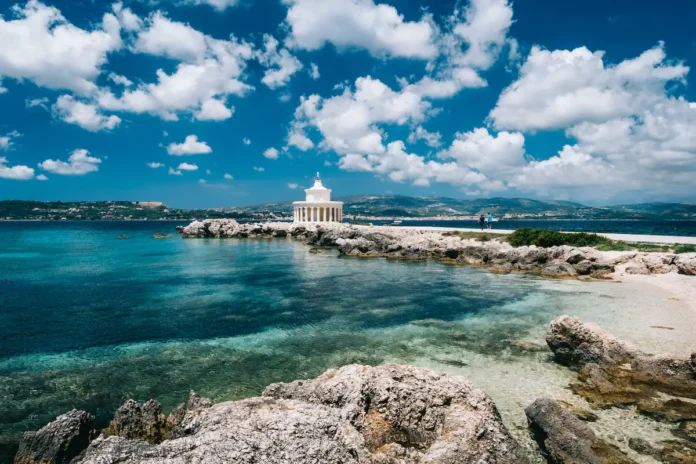 A circular Doric colonnade of the Saint Theodore Lighthouse (Fanari) against the turquoise sea of Argostoli, Kefalonia.