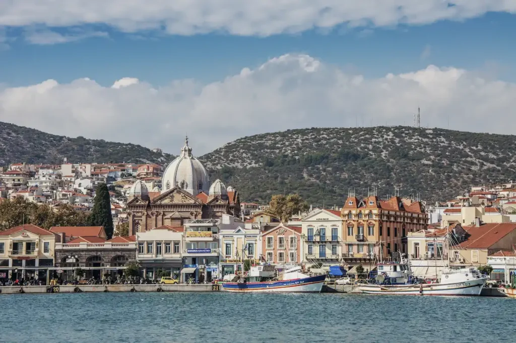 The urban waterfront of Mytilene featuring the large dome of the Agios Therapon church.
