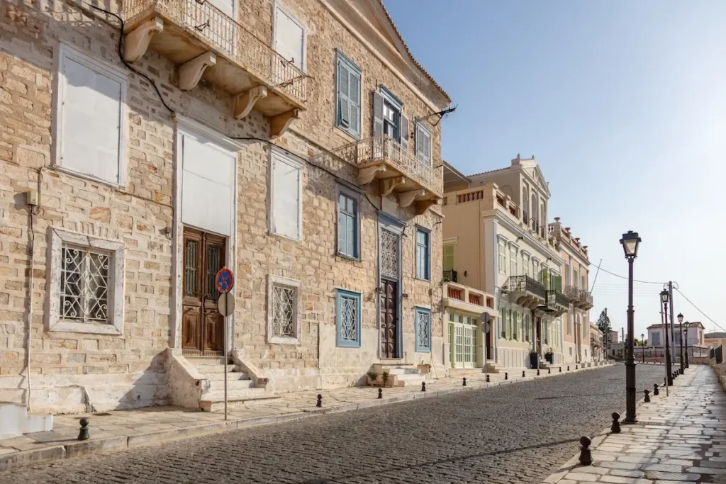 Colorful neoclassical doors and window shutters on a historic building in Ermoupoli.