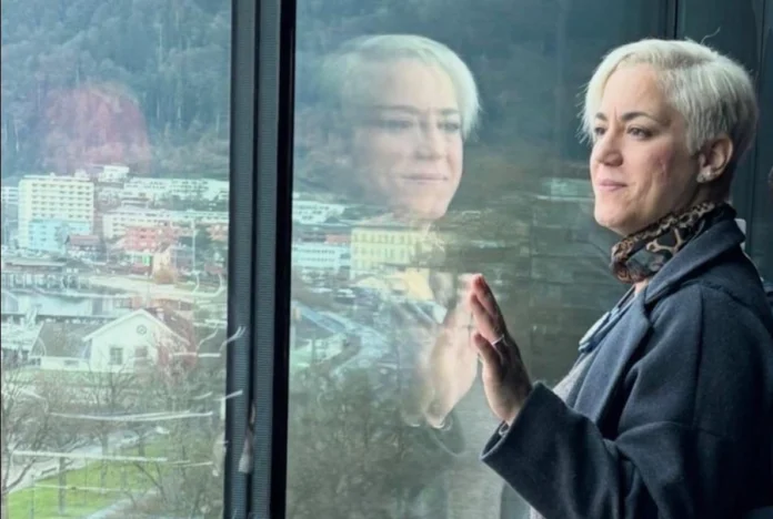portrait of Katerina Bali, architect and founder of B A A K Architecture, set against a backdrop emphasizing natural light.