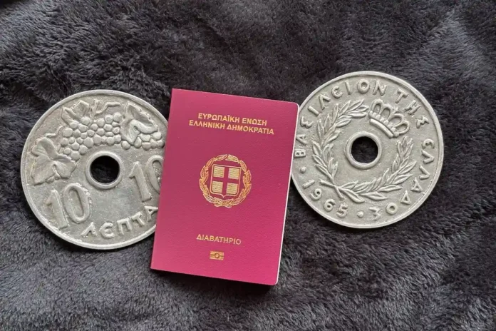 A Greek passport resting alongside oversized ceramic 'decares' coin sculptures by artist Christina Morali, representing the transition from the Drachma era to modern citizenship.