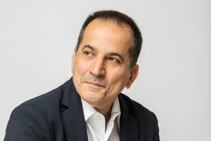 Portrait of Spiros Pengas, Thessaloniki City Council member, outdoors in a navy blue shirt