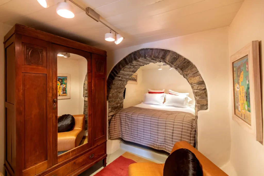 A stylishly renovated basement bedroom in a traditional Greek village house.