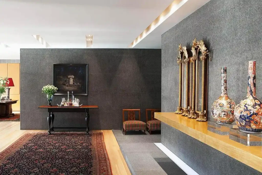 Athenian home entryway blending Chinese vases with ultra-modern concrete.