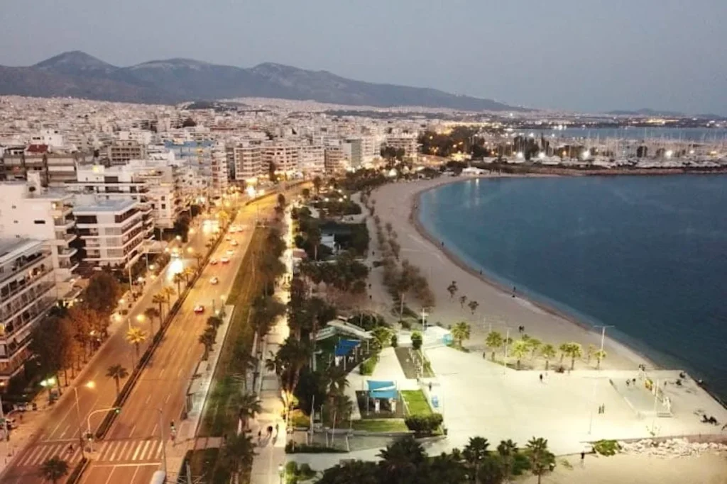 Aerial view of Palaio Faliro showing the organized grid of residential buildings adjacent to the coastal avenue and sandy shoreline.
