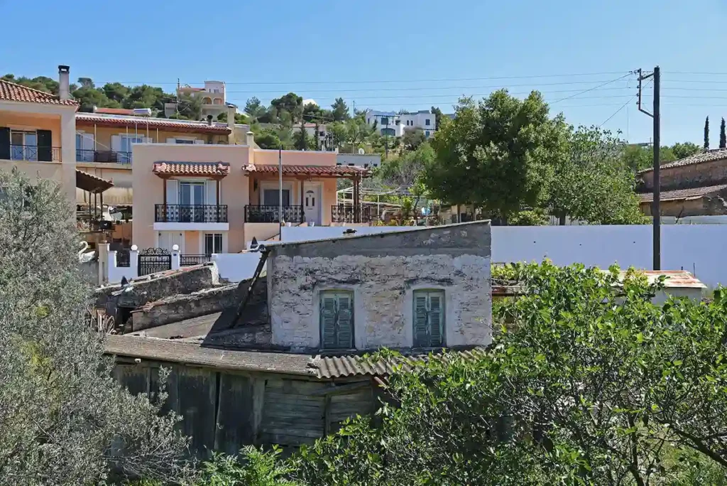 A peaceful scene in the village of Messagros showing local architecture and a quiet, sun-drenched atmosphere.
