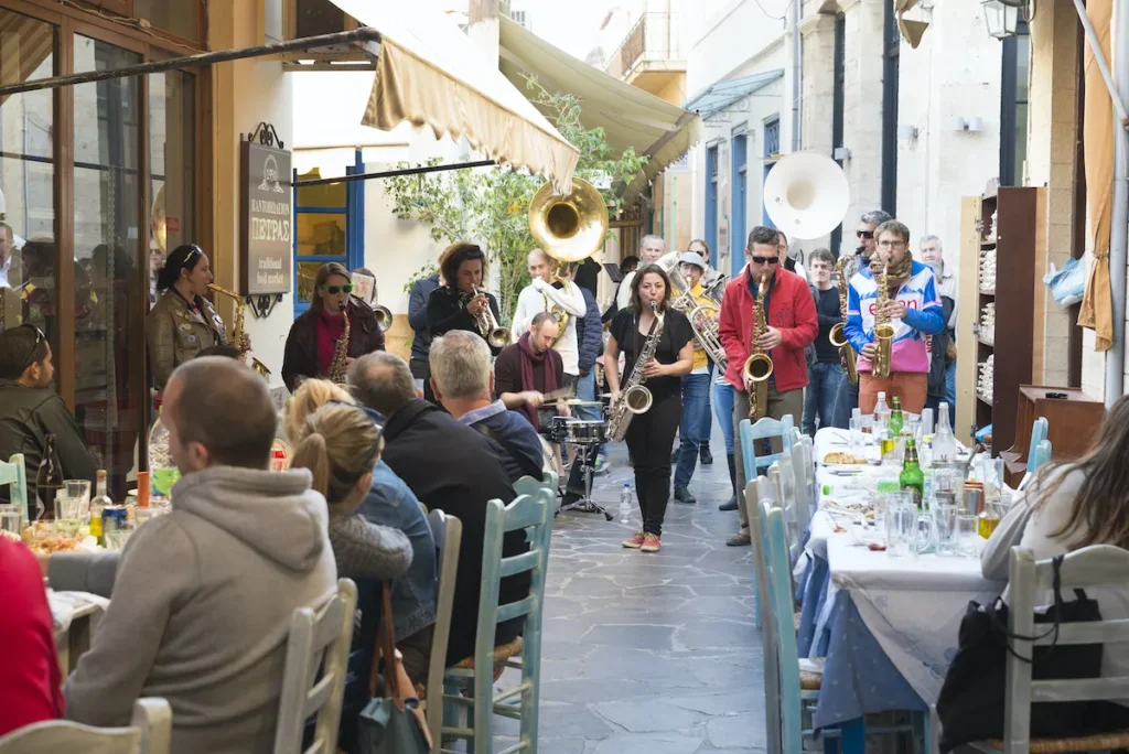 Saxophones band plays at an outdoor tavern in Aegina.