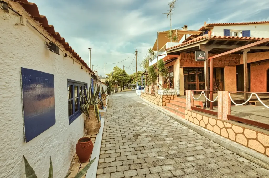 The main commercial street of Agia Marina showing the contrast between summer tourism and winter quiet.