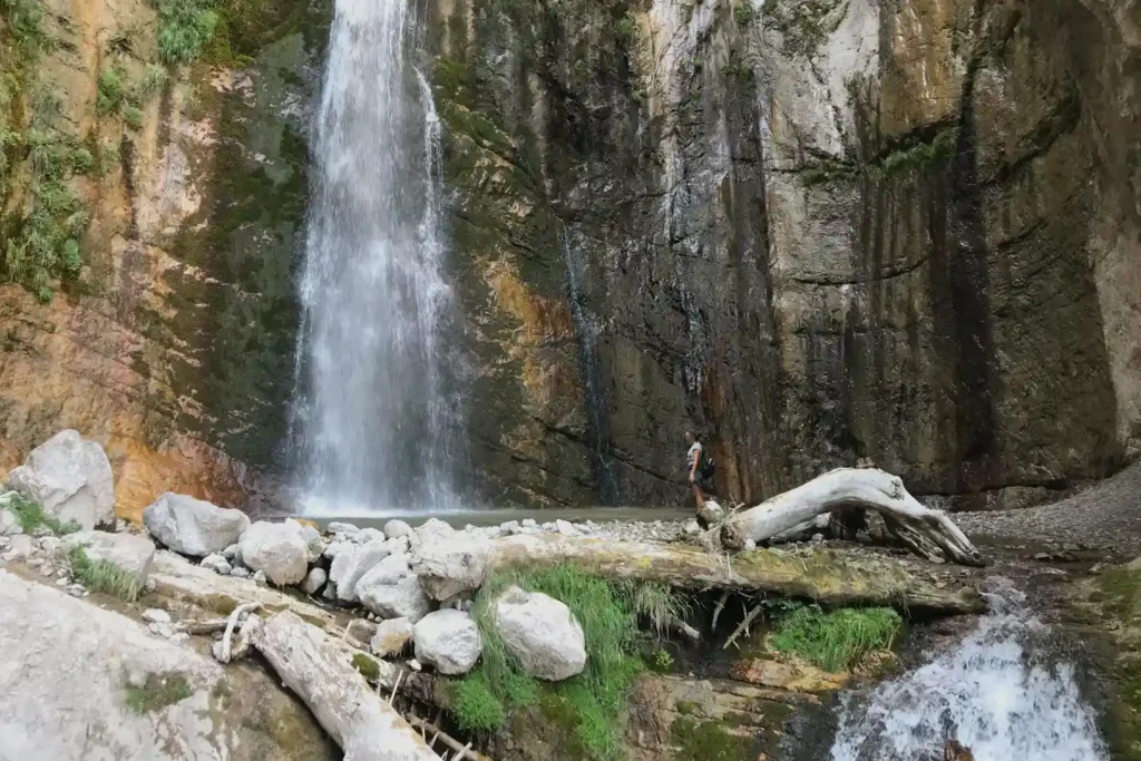 Hikers on a trail near the Tripis Waterfall in Central Greece.