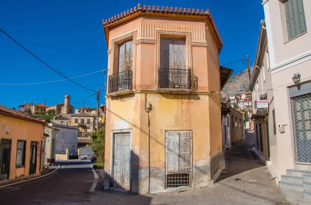 Narrow quiet streets in Chrisso village showing traditional houses with stone walls and wooden shutters.