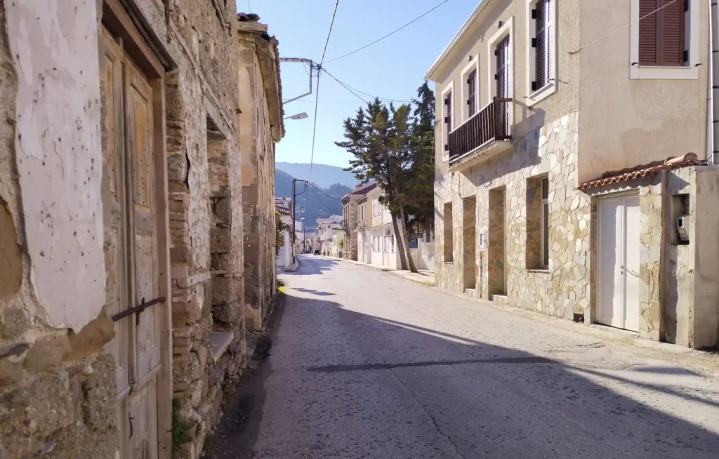 A picturesque street view in the village of Derveni, showing local architecture and a clean, walkable environment.