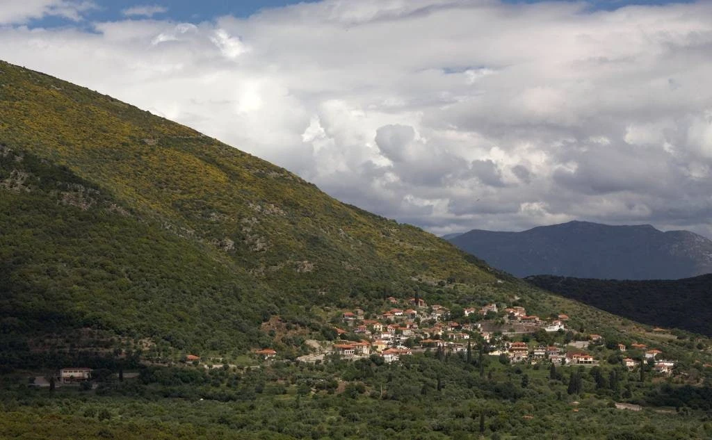 Panoramic view of Mavromati village nestled on the slopes of Mount Ithome, overlooking the archaeological valley of Ancient Messene.