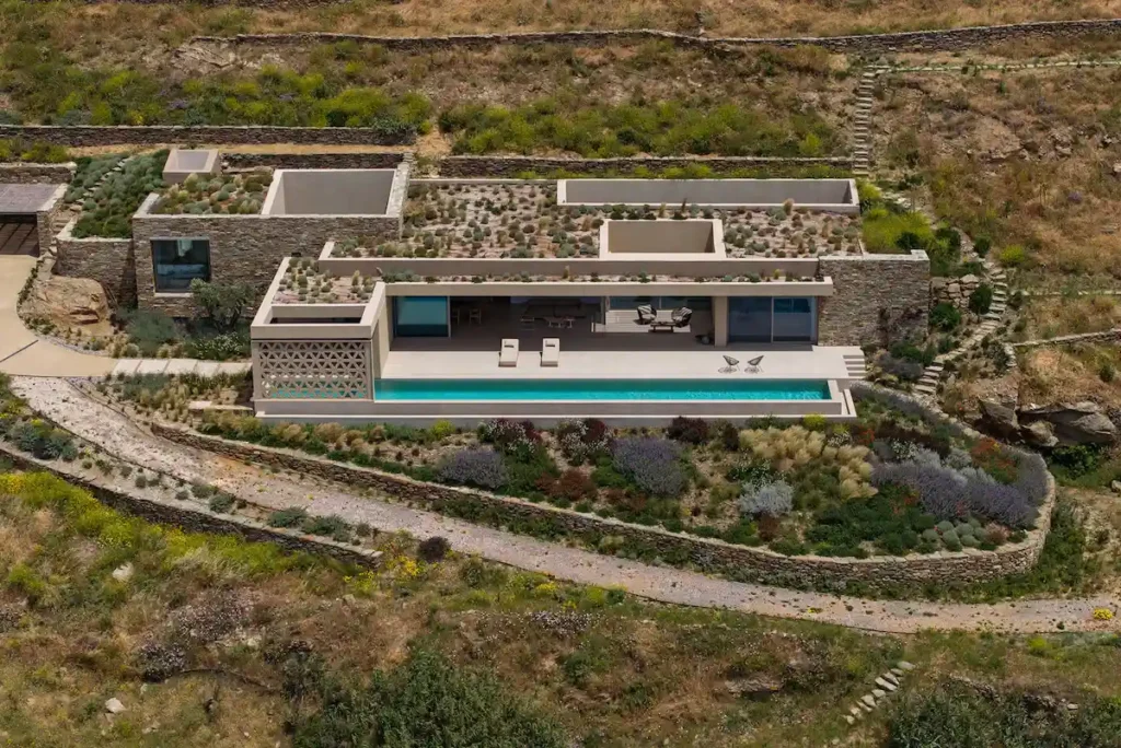 Traditional stone drywalls crisscrossing a sloped Greek landscape, separating plots of land in the Cyclades.