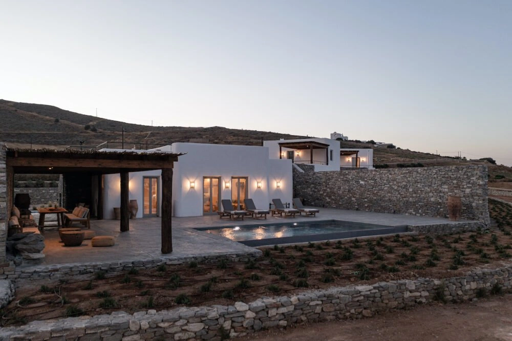 A modern Cycladic house in Antiparos, Greece, featuring white-washed minimalist architecture and a private plunge pool overlooking the Aegean Sea.