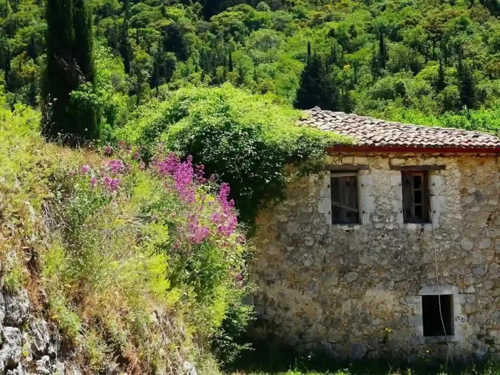 A traditional stone house with aged masonry in the mountainous village of Englouvi, Lefkada.