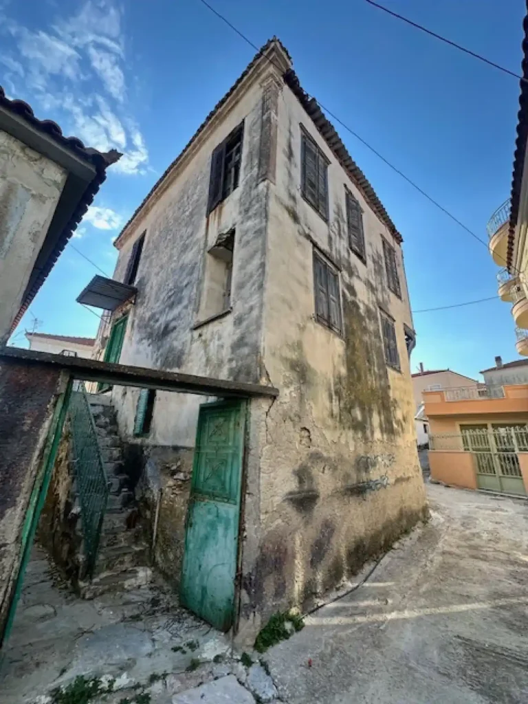 A traditional stone-built village house in Moria, Lesvos, featuring classic Mediterranean architectural details.