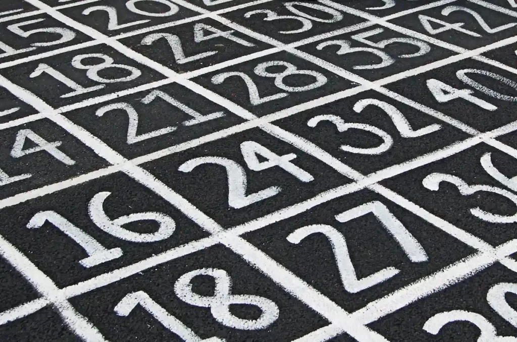 Numbers in black squares on a public floor, illustrating Greece's Personal Number system linking AFM, AMKA and public records.
