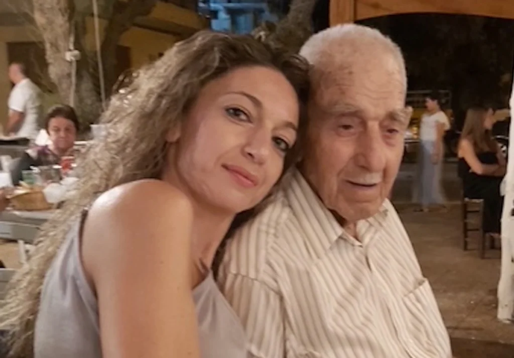 Realtor Paraskevi Gerakiti standing with her grandfather in Plomari, Lesvos.