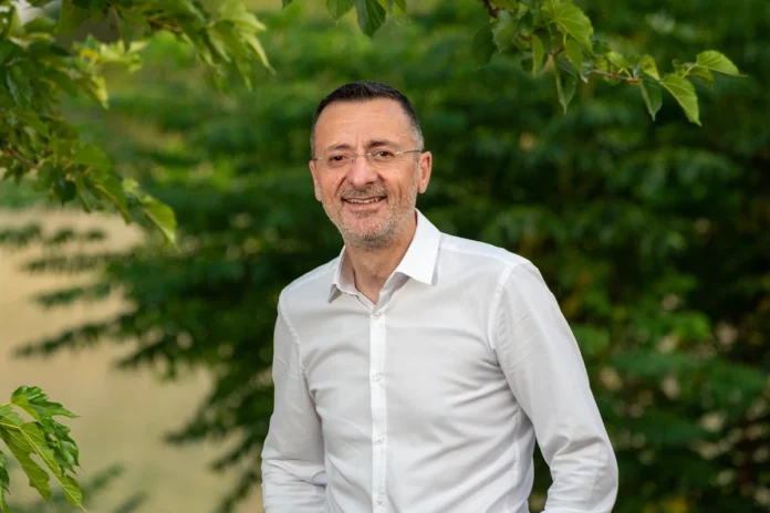 Mayor of Sikyon, Spyros Stamatopoulos, wearing a white shirt during an interview about retirement life in Kiato, Greece.
