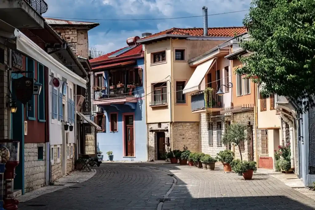 Old town street in Ioannina with decorative plant pots in front of a house