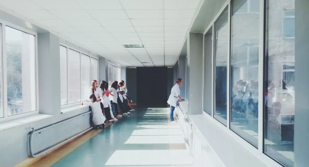 Medical staff walking through a hospital corridor representing hospital care in Greece.