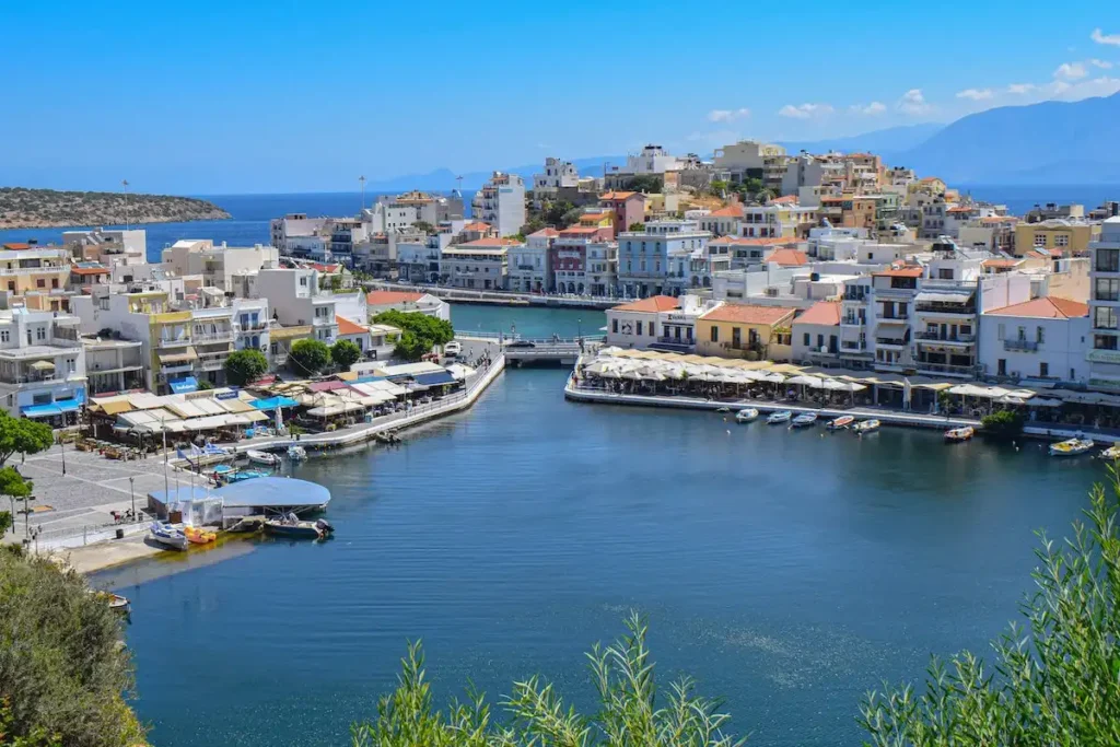 Scenic view of the coastal town of Agios Nikolaos built along the blue waters of Crete.