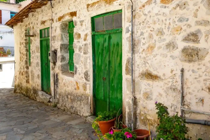 Stone house with bright green doors in Spili, Crete