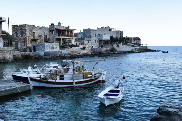 Stone houses and fishing boats in the harbor at Gerolimenas, Mani, Greece