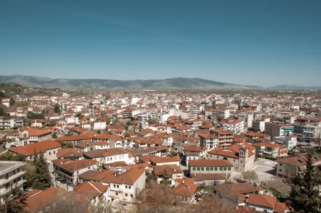 An aerial perspective of Trikala’s historic old town district with narrow streets and terracotta-roofed houses.