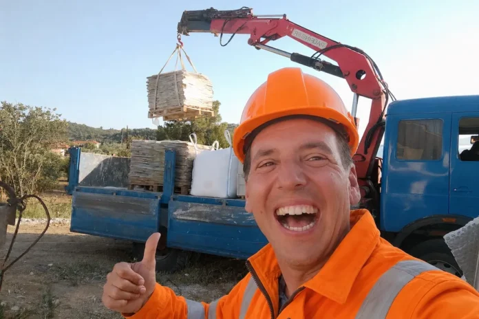 Maarten G. Verhoef checking flagstone materials on a construction site in Greece