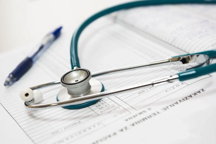 Stethoscope and pen resting on a medical report representing healthcare planning and medical services in Greece.