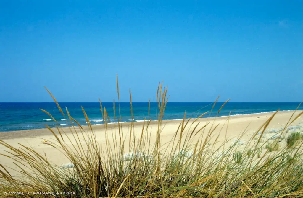 Wide view of the expansive sandy coastline at Zacharo beach along the Ionian Sea.