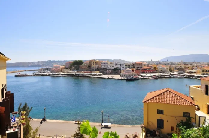 View across Chania's port with boats and the surrounding coastline
