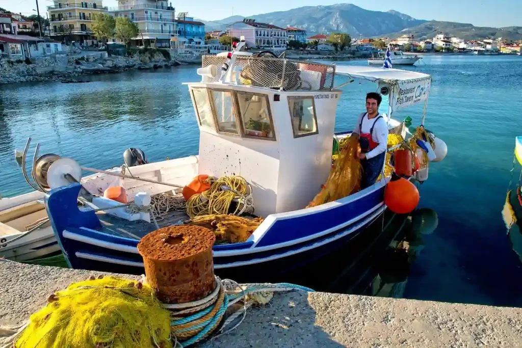 Traditional Greek wooden fishing boats moored at a tranquil harbor in Samos, Greece.
