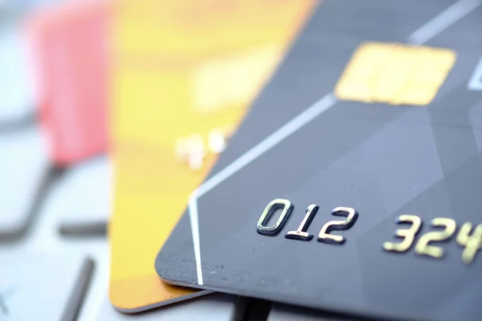 Close-up shot of a credit card resting on a sleek surface.