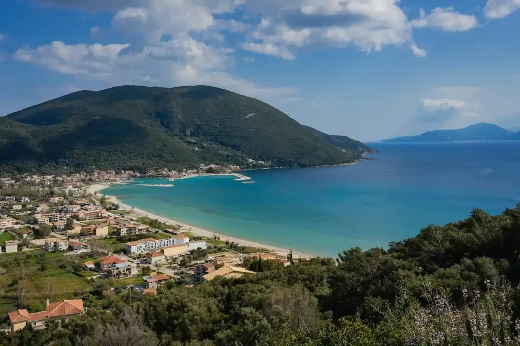 Aerial view of Vasiliki on Lefkada, with the beach and village between green mountains and the blue sea